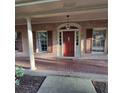 Inviting front porch with brick flooring, classic columns, and a warm, inviting ambiance at 1901 Arnold Dr, Austell, GA 30106