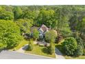 An aerial view showcasing a well-maintained home nestled among mature trees at 350 Covered Bridge Sw Pl, Smyrna, GA 30082