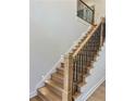 Modern staircase with wood treads, iron railing, and recessed lighting at 409 Saint Surrey Way, Ellenwood, GA 30294