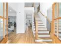 Bright foyer with hardwood floors, an elegant staircase, and views into the living spaces at 4100 Devon Wood Ne Dr, Marietta, GA 30066
