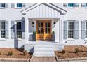 Inviting front porch with a double-door entrance, stylish planters, and classic gray shutters at 4100 Devon Wood Ne Dr, Marietta, GA 30066