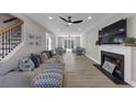 Spacious living room with fireplace, large TV, and cozy seating areas, and open staircase at 829 Verdun Way, Marietta, GA 30064