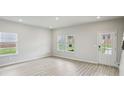Bright, spacious living room with large windows and modern flooring at 1280 Firefly Field Trce, Lawrenceville, GA 30045