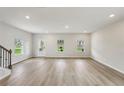 Bright, open-concept living room featuring sleek flooring, neutral walls, and plenty of natural light at 1290 Firefly Field Trce, Lawrenceville, GA 30045
