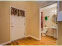 Convenient half bathroom featuring stylish fixtures, a pedestal sink, and a door to the outside at 1670 Cooper Lakes Dr, Grayson, GA 30017