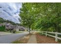 Picturesque street view showcasing well-maintained homes and lush greenery, creating a peaceful neighborhood setting at 1670 Cooper Lakes Dr, Grayson, GA 30017