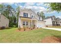 Well-maintained front yard with lush green grass, landscaping, and a view of the home's attractive exterior at 241 Martin Spring Rd, Lawrenceville, GA 30045