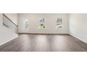 Bright living room featuring laminate floors and natural light from two front windows at 1270 Firefly Field Trce, Lawrenceville, GA 30045