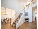 Bright foyer showcasing a staircase with wooden railings and hardwood floors at 2019 Chelton Se Way, Smyrna, GA 30080