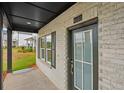 Close-up of a home's front porch featuring a stylish front door and brick siding at 4680 Hemingway Trl, Cumming, GA 30041