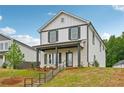 Charming two-story home with a covered front porch and neatly landscaped yard at 4680 Hemingway Trl, Cumming, GA 30041