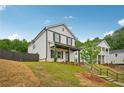 Charming exterior with a welcoming porch and neat landscaping on a sunny day at 4680 Hemingway Trl, Cumming, GA 30041