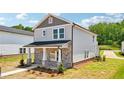 Beautiful two-story home with stone accents, gray siding, and a well-manicured lawn at 4690 Hemingway Trl, Cumming, GA 30041