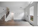 Bright foyer showcasing new flooring, coat rack, and natural light from large windows, and a modern style at 315 Mckees Rock Ln, Lawrenceville, GA 30044