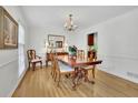 Elegant dining room featuring hardwood floors, a chandelier, and classic wood furniture at 1569 Chateau Dr, Dunwoody, GA 30338