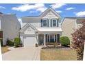 Inviting two-story home with charming curb appeal, a bench on the porch, a well-manicured lawn, and a driveway at 1711 Taynton Cir, Kennesaw, GA 30152