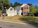 Two-story home with a brick accent and a two-car garage on a sunny day at 4018 Dorchester Nw Walk, Kennesaw, GA 30144
