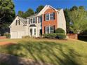 Attractive two-story home with gray siding, a brick accent, and a manicured lawn at 4018 Dorchester Nw Walk, Kennesaw, GA 30144