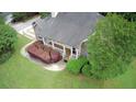 Aerial view of home showing covered porch, manicured landscaping and a large, well-maintained lawn at 25 Derby Dr, Hiram, GA 30141