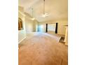 Spacious living room featuring a fireplace, vaulted ceilings, carpeted floors, and natural light at 25 Derby Dr, Hiram, GA 30141