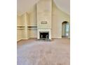 Living room featuring a fireplace, vaulted ceilings, carpeted floors, and an open layout at 25 Derby Dr, Hiram, GA 30141