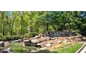 Picturesque Soleil community entrance with water feature, landscaping and natural rock at 408 Windy Ridge Way, Canton, GA 30114