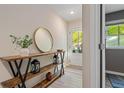 Inviting entryway featuring wood console table with decor and view of outdoors at 711 Needletail Way, Atlanta, GA 30312