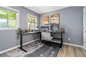 Comfortable home office features a large desk, stylish decor, and natural light at 711 Needletail Way, Atlanta, GA 30312