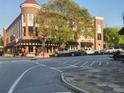 Charming brick building with a round turret and sidewalk seating at 1133 Church St # 6, Covington, GA 30014