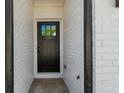 Elegant front door with glass pane and brick surround, showcasing the entrance to this lovely home at 125 Auburn Gate Ln, Auburn, GA 30011