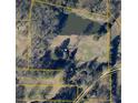 Aerial view of property with pond and ample land in a wooded area on New Hope Cir at 177 New Hope Cir, Fayetteville, GA 30214