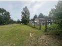 Sprawling backyard view with shed and wooden deck on a well-maintained lawn at 177 New Hope Cir, Fayetteville, GA 30214