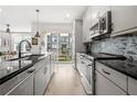 Modern kitchen featuring sleek gray cabinets, dark countertops, and stainless steel appliances, ideal for cooking and entertaining at 383 Pratt Se Dr # 506, Atlanta, GA 30315