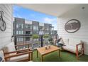 Cozy outdoor patio with furniture, artificial grass, and a view of the surrounding townhomes at 383 Pratt Se Dr # 506, Atlanta, GA 30315