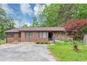 Charming single story brick home with a spacious driveway and partially manicured lawn at 9186 Puckett St, Covington, GA 30014