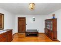 Inviting living room with beautiful hardwood floors, elegant light fixture, and dark wood furniture at 9186 Puckett St, Covington, GA 30014