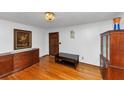 Inviting living room with beautiful hardwood floors, elegant light fixture, and dark wood furniture at 9186 Puckett St, Covington, GA 30014