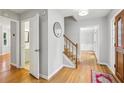 Inviting entryway featuring hardwood floors, staircase, and access to the bathroom at 1520 N Milford Creek Sw Ln, Marietta, GA 30008