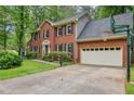 Two-story brick home with a two-car garage and basketball hoop on a sunny day at 1520 N Milford Creek Sw Ln, Marietta, GA 30008