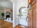Inviting entryway with wood door, table, and decor, flowing into a living room with a fireplace at 333 Mimosa Dr, Decatur, GA 30030
