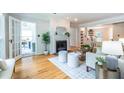 Open-concept living room featuring a fireplace, hardwood floors, and French doors to an office at 333 Mimosa Dr, Decatur, GA 30030