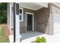 Inviting front porch with brick detailing and a stylish front door at 612 Belshire Dr, Acworth, GA 30102