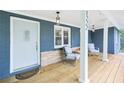 Inviting covered porch area with brick siding and outdoor seating at 1222 Crestwood Se Dr, Atlanta, GA 30316