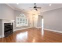 Bright living room with hardwood flooring, fireplace, ceiling fan, and natural light at 1640 Arbor Green Nw Ct # 1102, Kennesaw, GA 30152