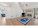 Inviting living room featuring a stone fireplace, vaulted ceilings, wood floors, and large windows at 2849 Shiaway Trl, Snellville, GA 30039
