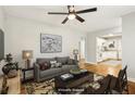 Cozy, virtually staged living room with neutral colors, hardwood floors, and a kitchen view at 3417 Glen Rd, Decatur, GA 30032