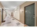 Long hallway with neutral walls and patterned tile flooring leading to various doors at 400 17Th Nw St # 1315, Atlanta, GA 30363