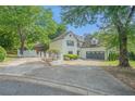 Elegant two-story home with landscaped yard, brick accents, and a spacious driveway leading to a two car garage at 1751 Bergen Ct, Lawrenceville, GA 30043