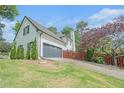 Well-maintained two-story home featuring a brick exterior, a two-car garage, and a beautifully landscaped lawn at 1751 Bergen Ct, Lawrenceville, GA 30043