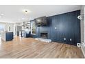 Open-concept living area featuring hardwood floors, a fireplace, and seamless flow to the modern kitchen at 41 Jessica Ln, Dallas, GA 30157